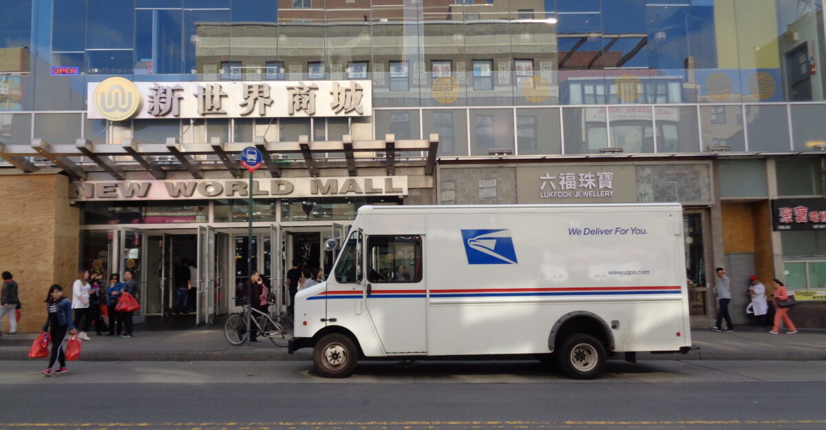 A USPS delivery truck in front of the New World Mall on Roosevelt Avenue west of Main Street in Downtown Flushing Queens