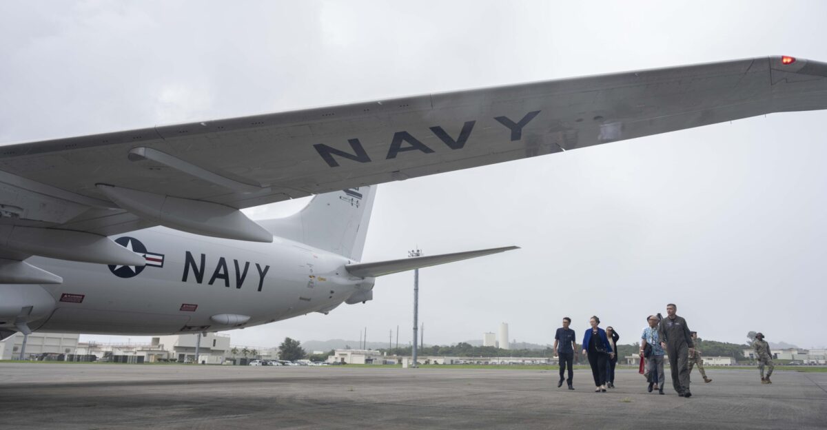 KADENA AIR BASE Japan Vistors from the Okinawa Defense Bureau observe a P-8 Poseidon attached to the Golden Eagles of Patrol Squadron VP 9 during a brief by Capt Joseph Parsons Commander Fleet Activities Okinawa CFAO while touring U S Navy assets on Kadena Air Base Aug 4 2025 CFAO maintains and operates facilities to support United Nations Command-Rear missions coalition and allied partners U S Navy ships submarines and aircraft and Joint Force assets in the Indo-Pacific region U S Navy Photo by Mass Communication Specialist 2nd Class Zack Guth