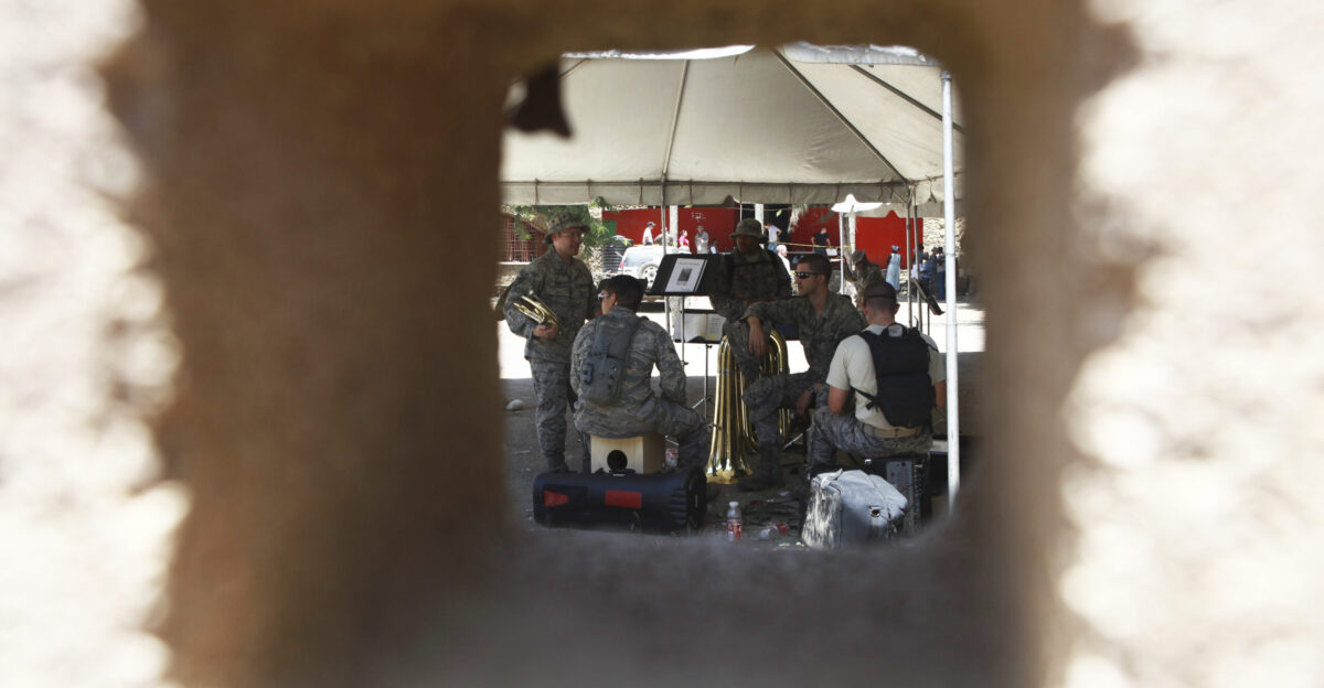 U S Air Force members of New Harmony Air Force Band of Flight attached to Operation Continuing Promise 2010 take a break from the mid-day heat while performing at a medical site in Port-de-Paix Haiti Aug 1 for Haitians waiting in line to receive medical care CP10 is a collaborative effort that involves military and civilian personnel providing humanitarian assistance and disaster relief to the Caribbean Central and South America