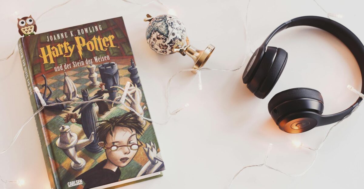 Minimalist setup with Harry Potter book headphones and string lights for a cozy reading experience