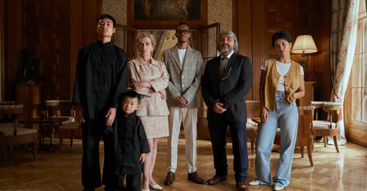 A diverse family poses together in a luxurious indoor setting showcasing generational and cultural richness