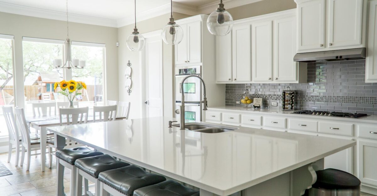 Spacious modern kitchen with white cabinets and island in natural light