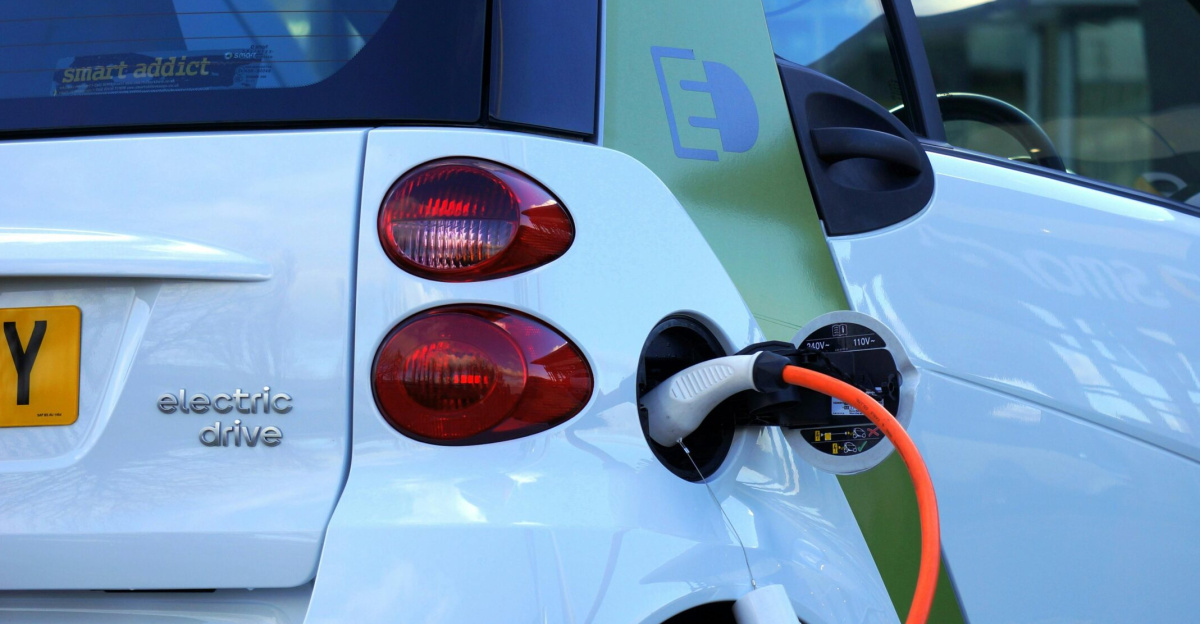 Close-up of an electric car being charged, highlighting eco-friendly transportation.