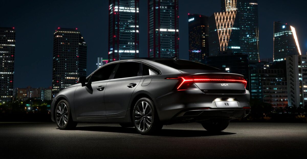 Stylish black car parked with illuminated Seoul skyline in the backdrop Modern urban vibe
