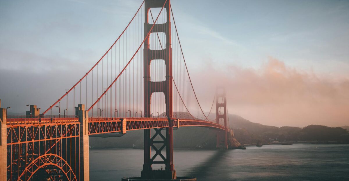 Golden Gate Bridge shrouded in fog during sunset San Francisco