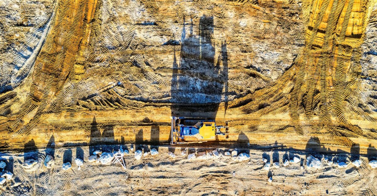 Top view of an excavator on a sunlit construction site in Rochester MN
