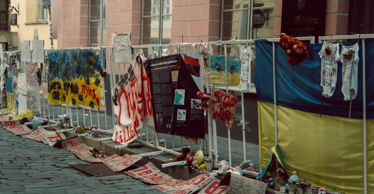 Protest display with banners and toys on a Tallinn street symbolizing anti-war sentiment