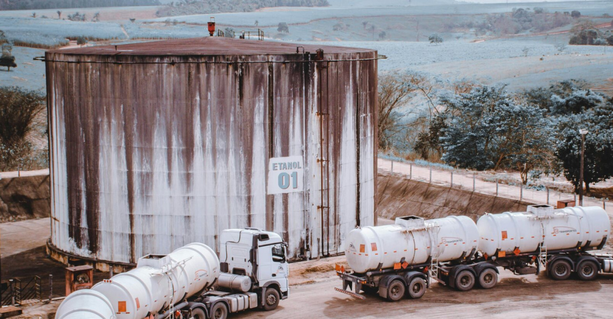 Aerial view of industrial trucks near a large silo in Serra dos Aimorés, Brazil.