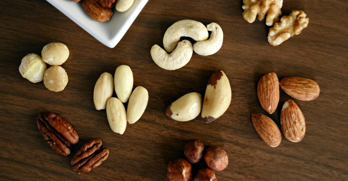 Close-up of various nuts on a wooden table showcasing healthy snacking options