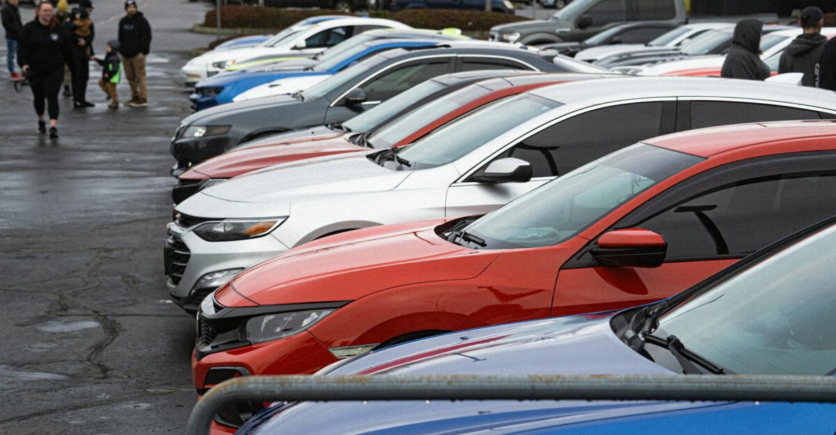 A vibrant lineup of parked cars in an outdoor parking lot setting