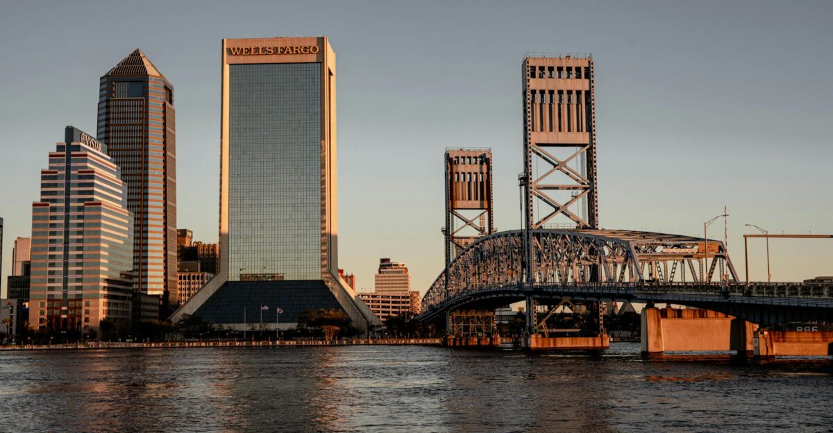 Stunning view of Jacksonville FL skyline at sunset with iconic bridges and modern skyscrapers reflecting on the water