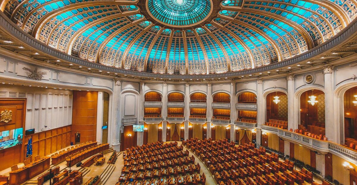 Vibrant interior of a parliament hall with a grand dome and intricate architecture
