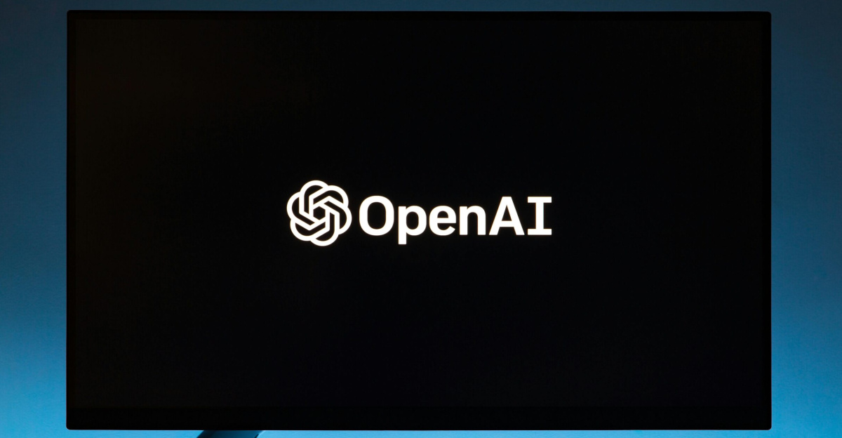 Minimalist display of OpenAI logo on a screen, set against a gradient blue background.