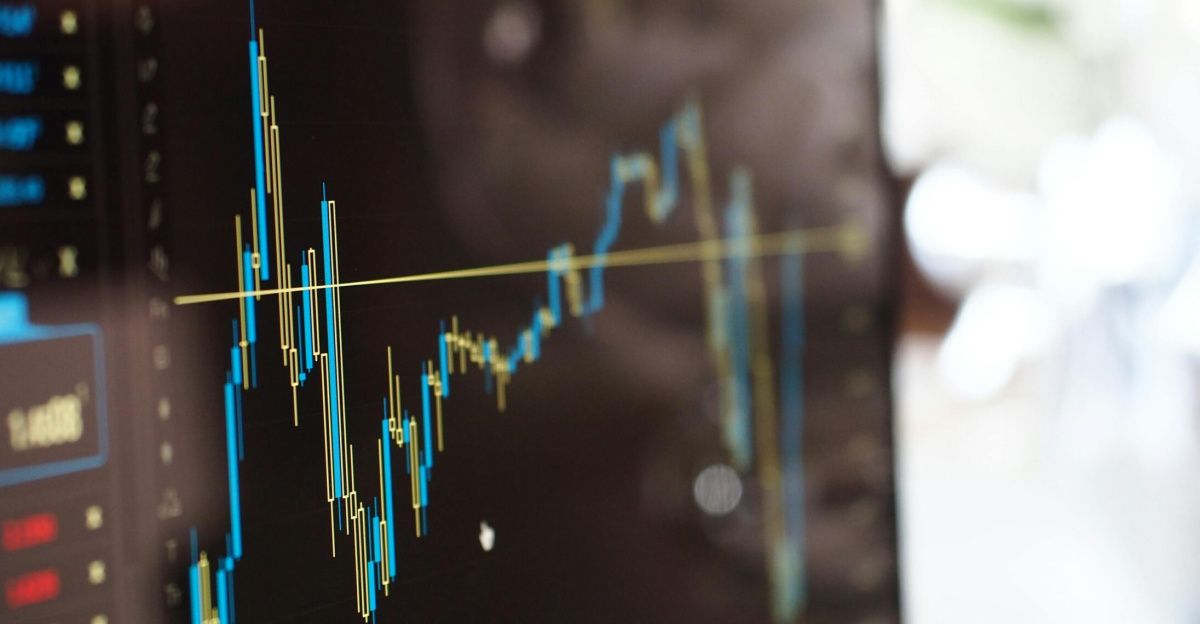 Detailed view of financial trading graphs on a monitor, illustrating stock market trends.