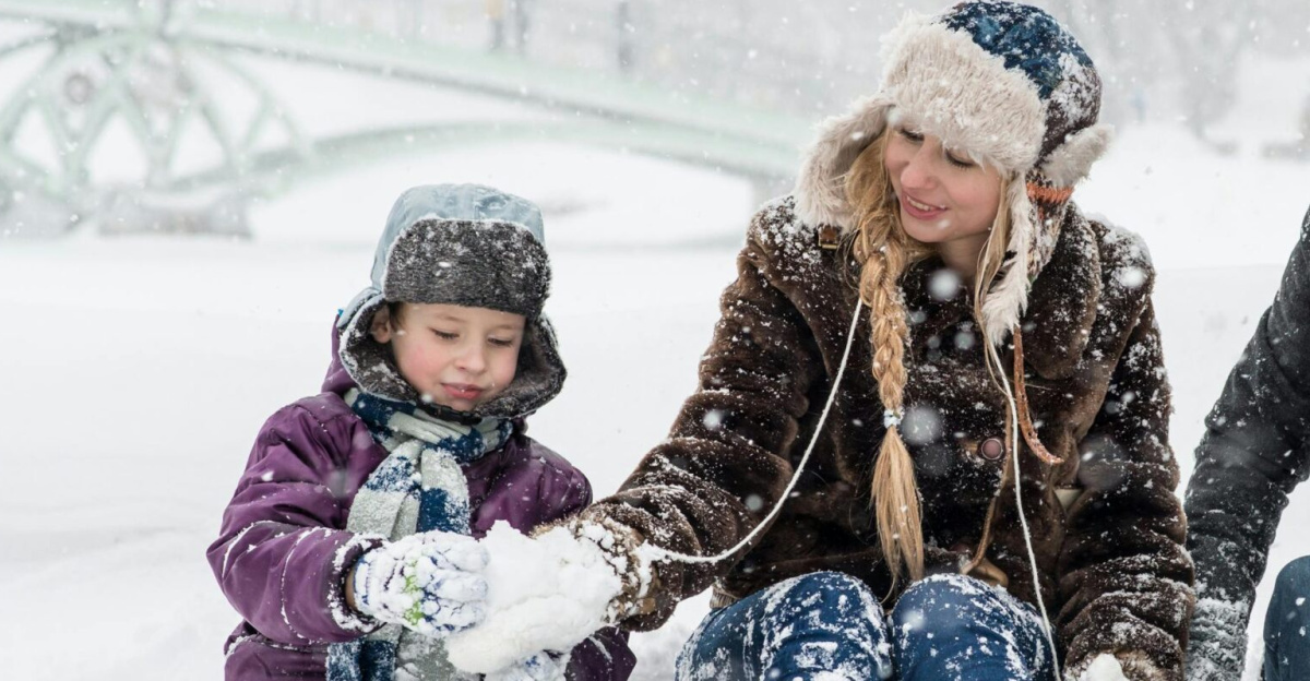 Happy family enjoying playful time in snowy winter park, capturing joyful moments in nature.