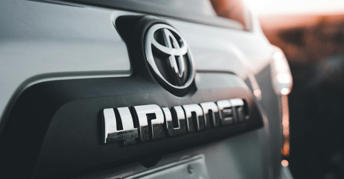 Detailed close-up of a Toyota 4Runner emblem highlighted by the warm sunset light