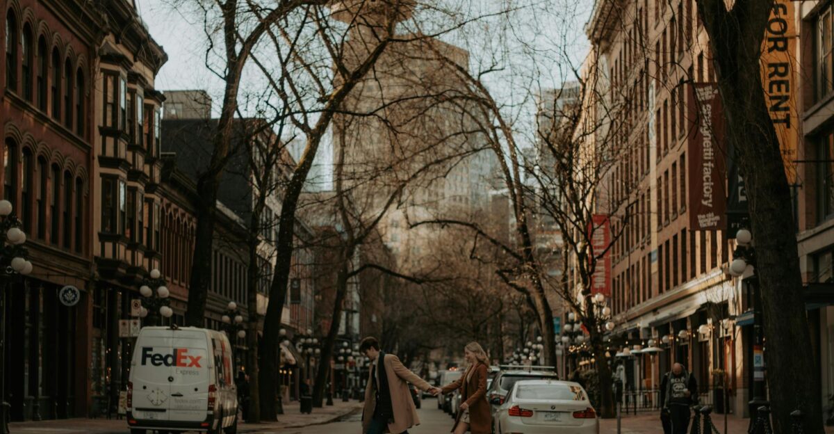 Couple crossing a street in a stylish urban setting wearing fashionable coats