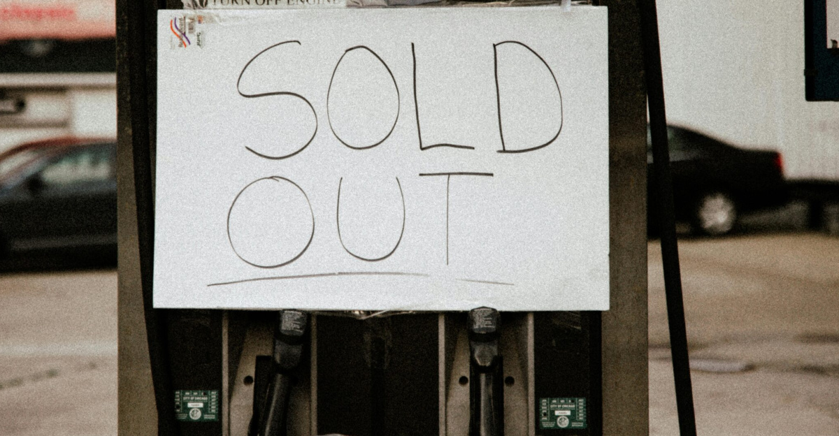 A gas pump at an urban station displaying a 'Sold Out' sign, illustrating fuel shortage.