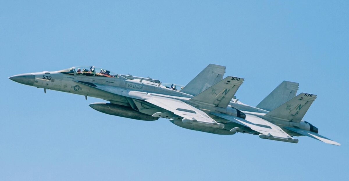 F A-18 Super Hornets flying in formation in a clear blue sky over New York