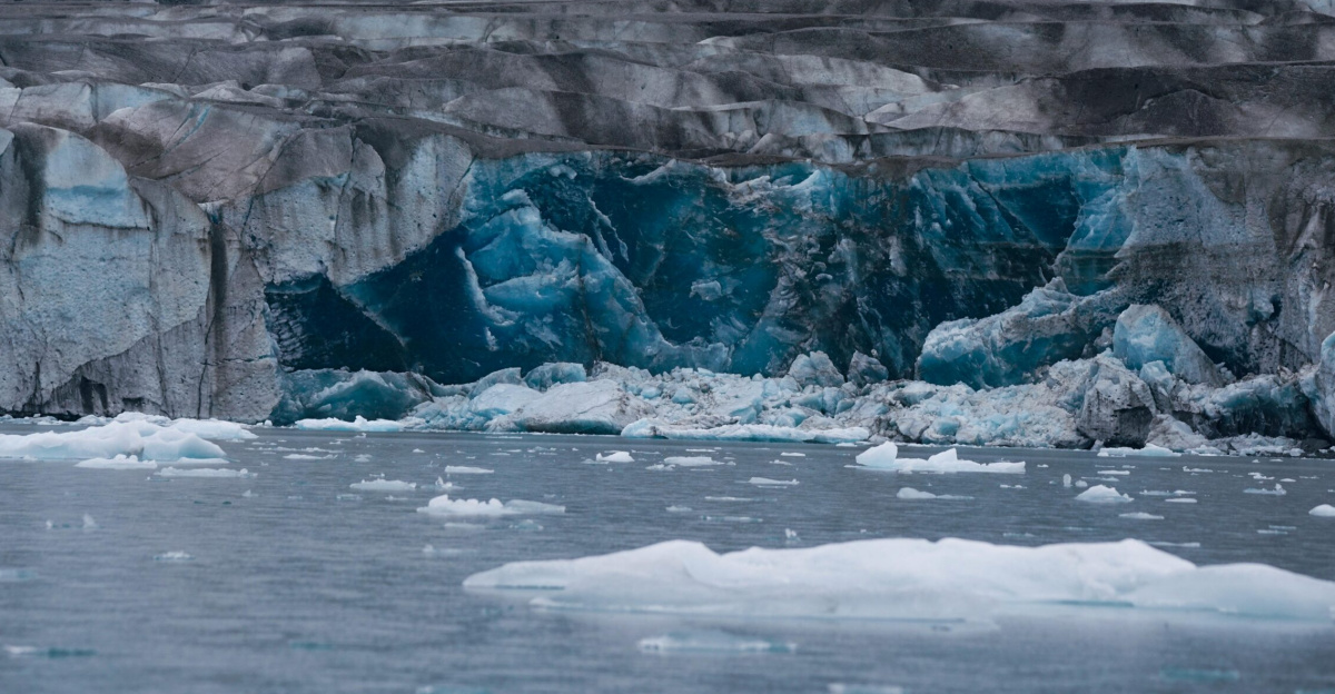 A stunning view of a glacier with icebergs floating in the cold water.