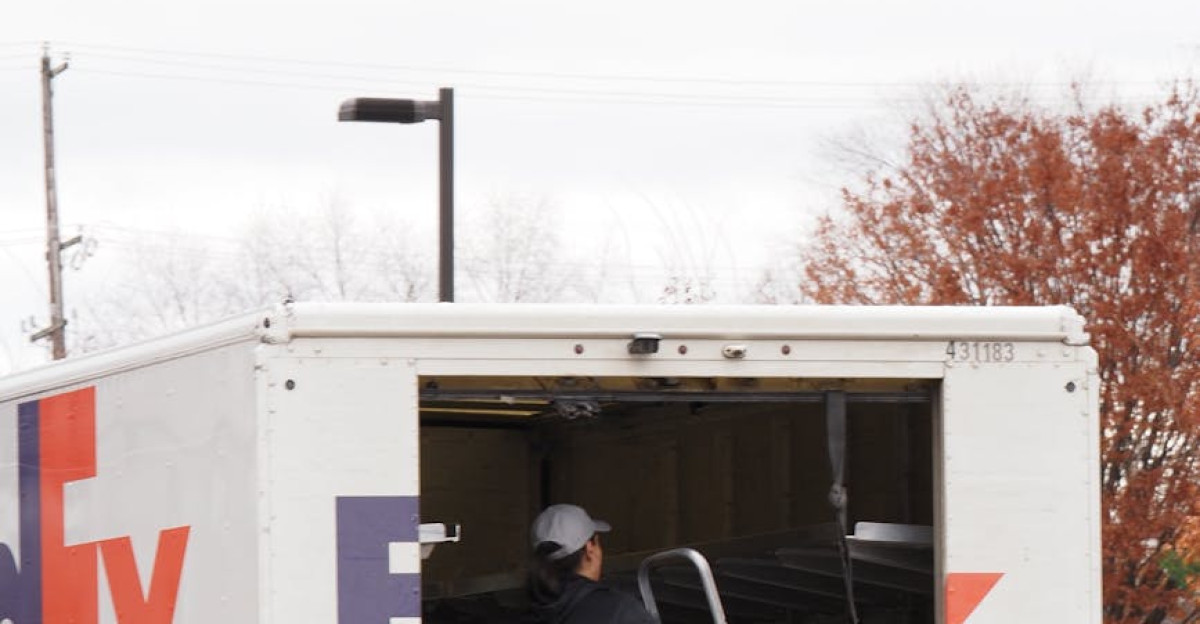 Courier unloading packages from FedEx truck in urban area Efficient package delivery in Willow Grove PA