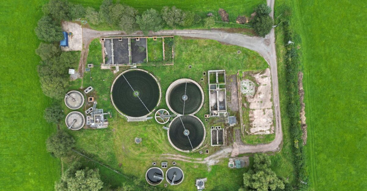 Aerial view of a wastewater treatment plant surrounded by lush greenery in Crickhowell Wales