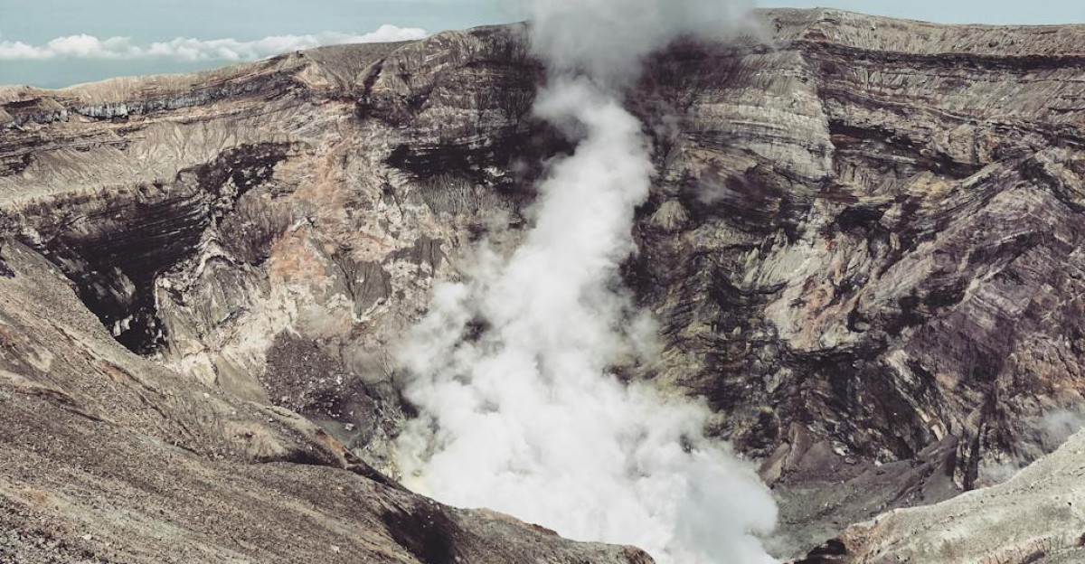 Smoke rises from the volcanic crater of Mount Aso Japan highlighting its geothermal activity