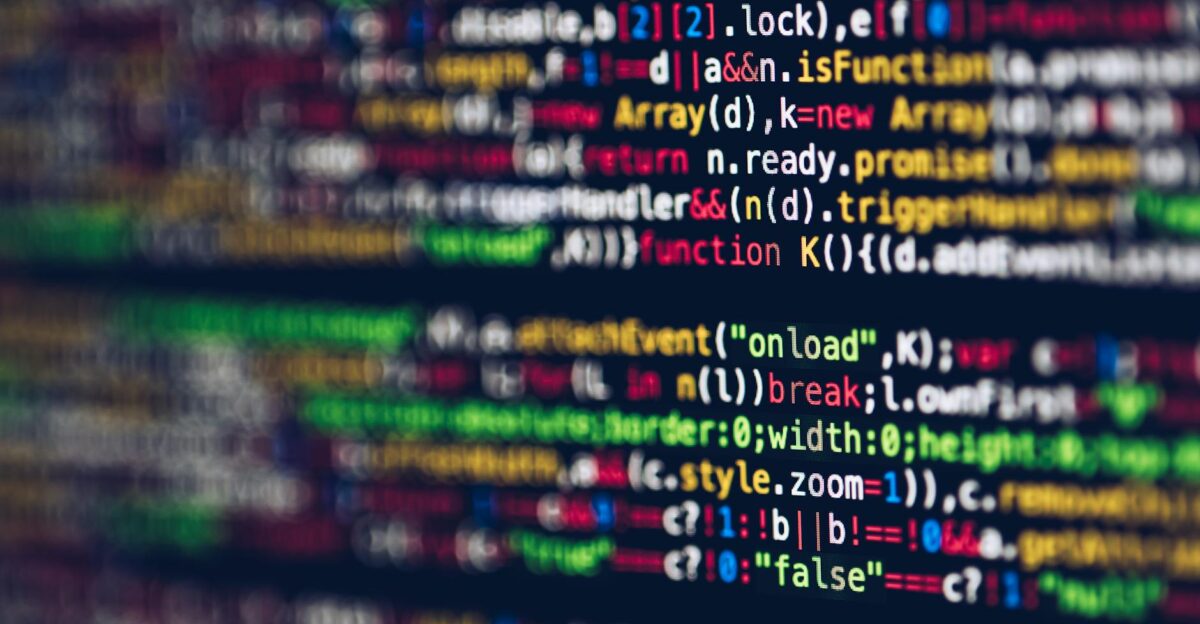 Vivid blurred close-up of colorful code on a screen representing web development and programming