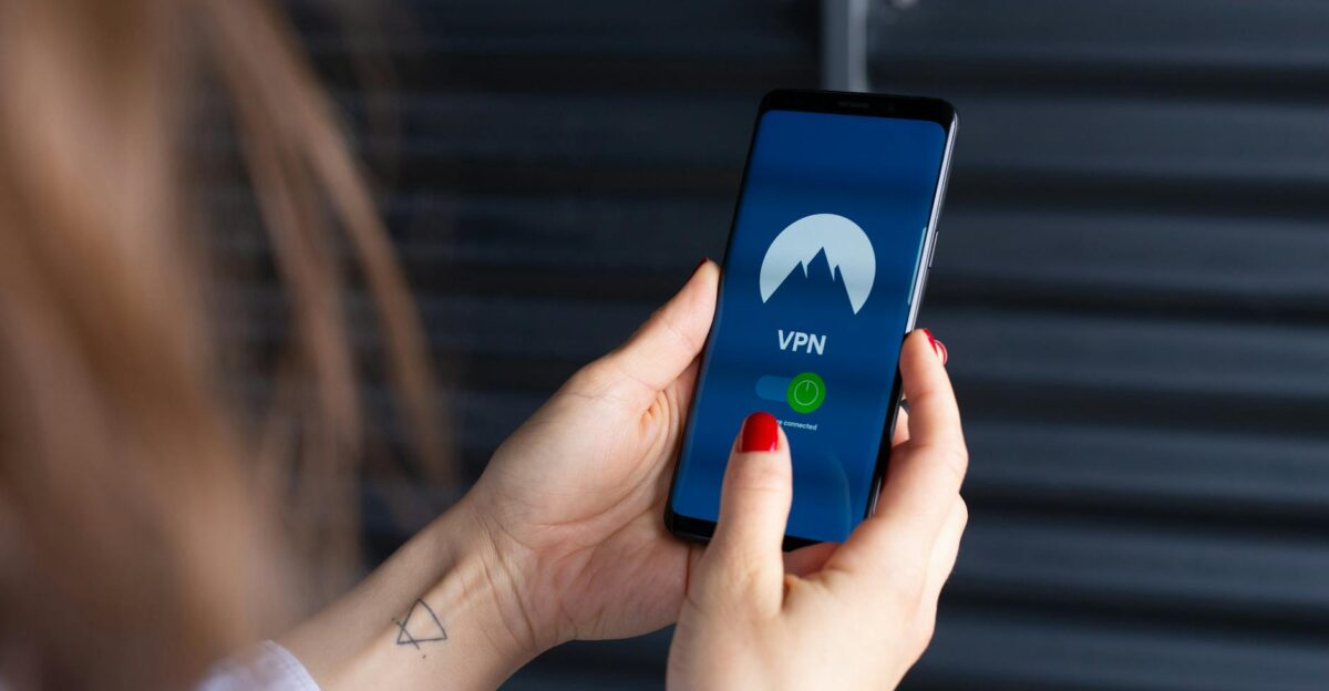Close-up of a woman s hands using a VPN app on a smartphone emphasizing digital security