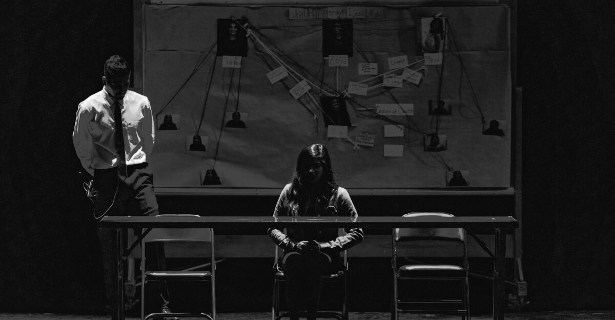 Black and white scene depicting a tense interrogation with suspect and investigator