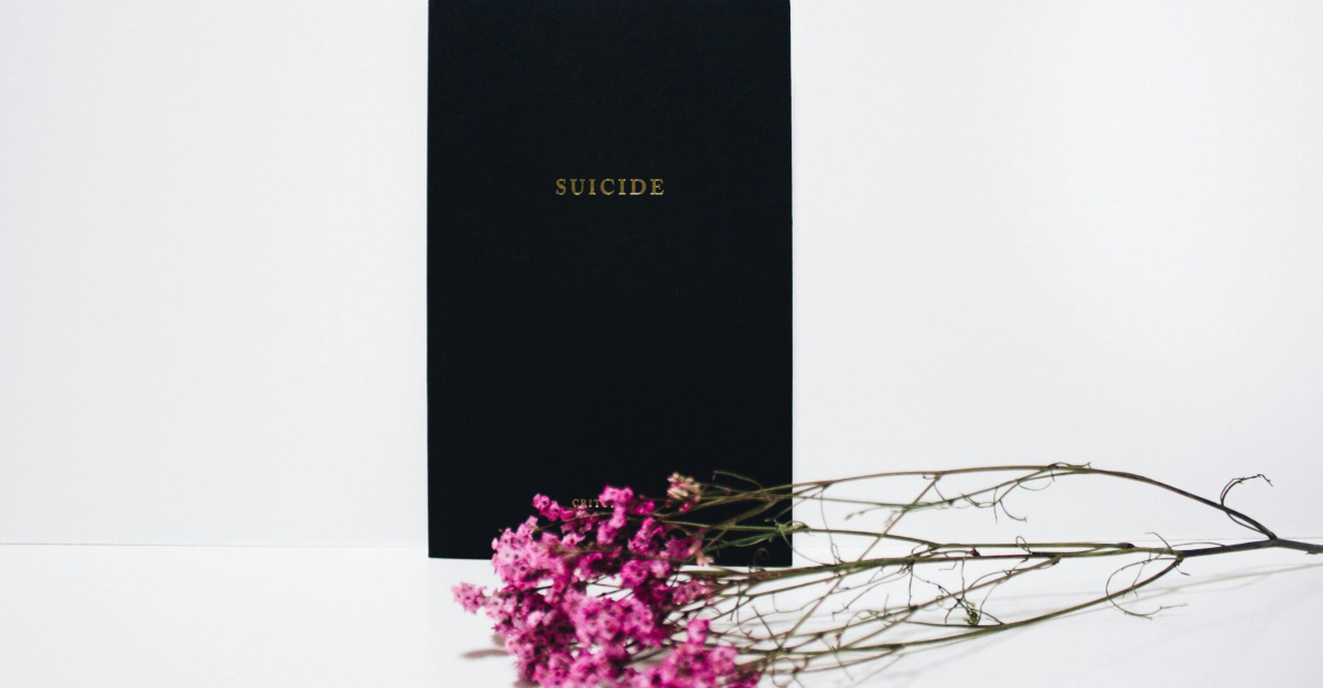 Minimalist art highlighting suicide awareness with flowers on a white background.