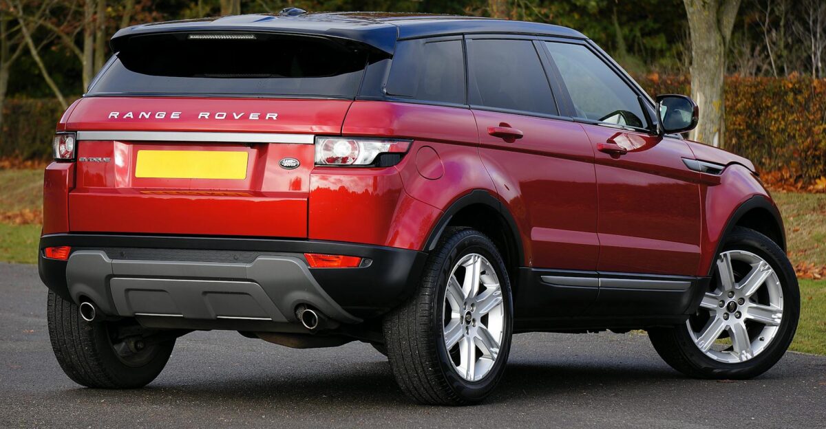 Elegant red Range Rover SUV parked outdoors on a clear day showcasing its luxury and style