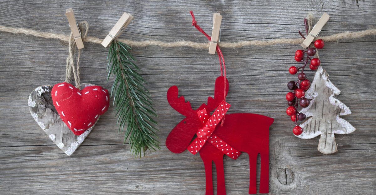 Heartfelt rustic Christmas decorations on wood featuring a red moose heart and tree
