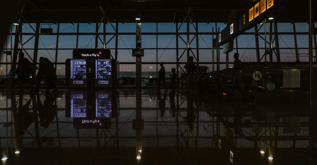 Silhouettes and reflections inside Brussels Zaventem Airport during twilight