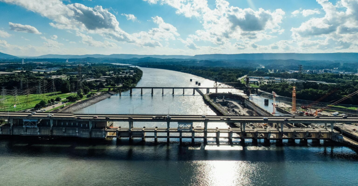 Scenic aerial shot of a bridge and dam on a sunny day in Chattanooga, Tennessee.