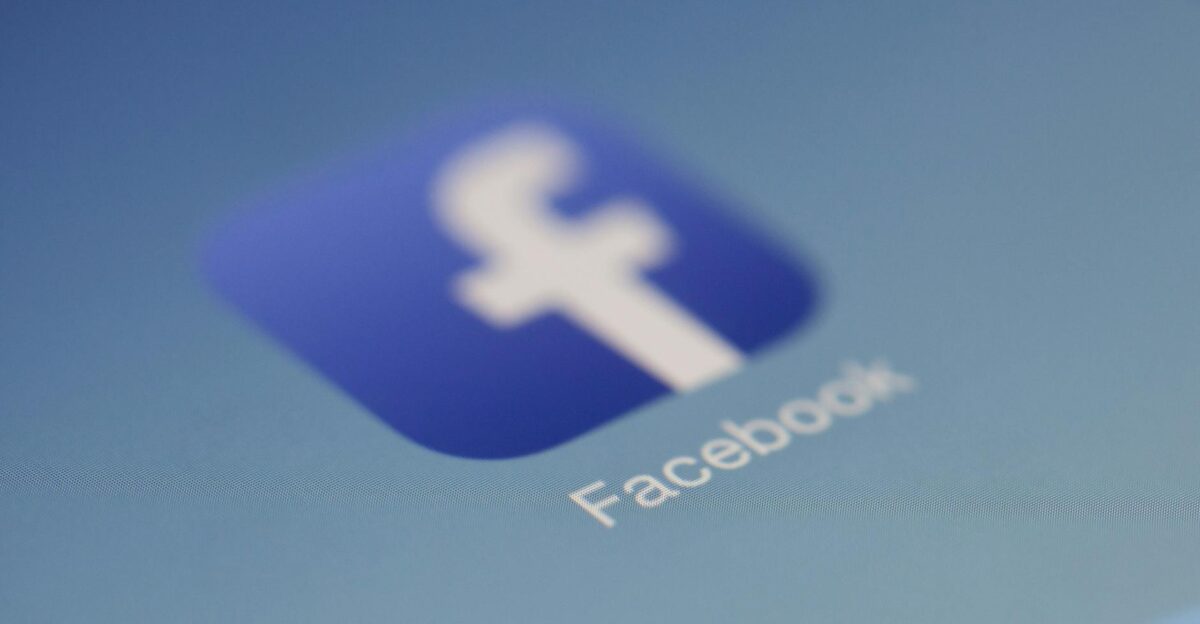 Close-up view of the Facebook app logo on a digital screen with blurred background