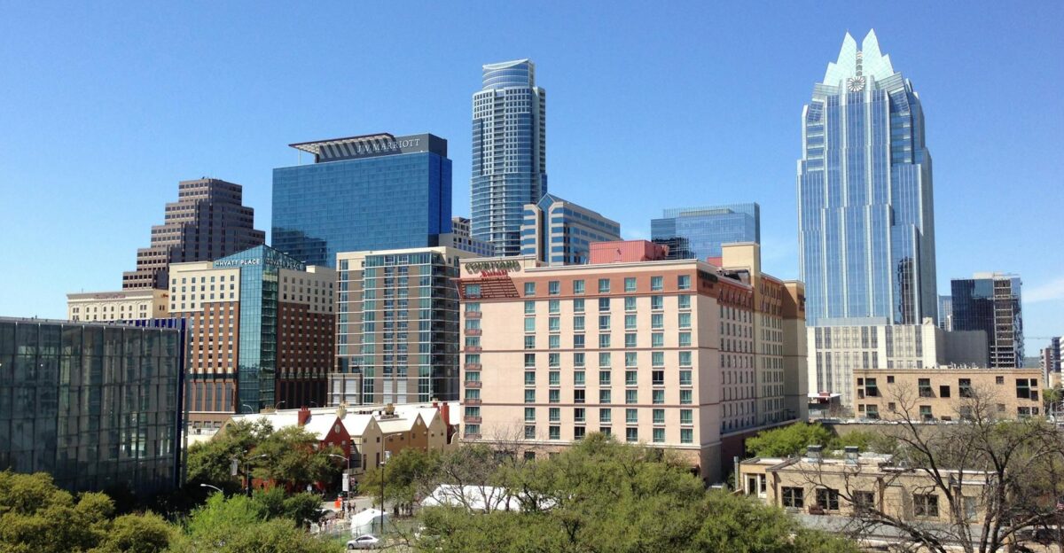 A vibrant daytime cityscape of downtown Austin showcasing modern architecture and towering skyscrapers