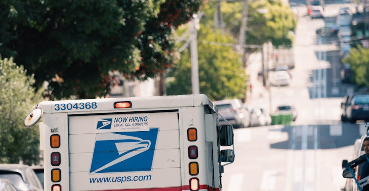 USPS truck driving down a busy urban street capturing everyday city life