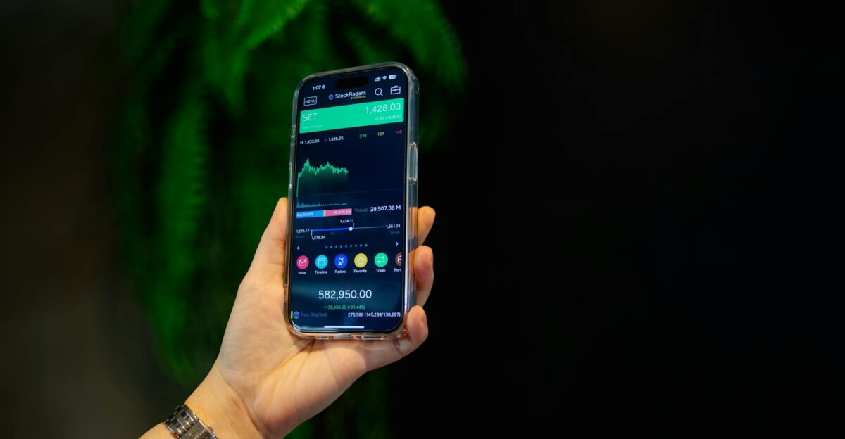 Close-up of a smartphone displaying a stock trading app with market data on-screen
