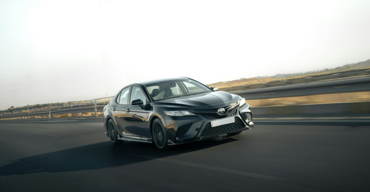 A sleek Toyota Camry in motion on a highway, capturing the essence of speed and style.