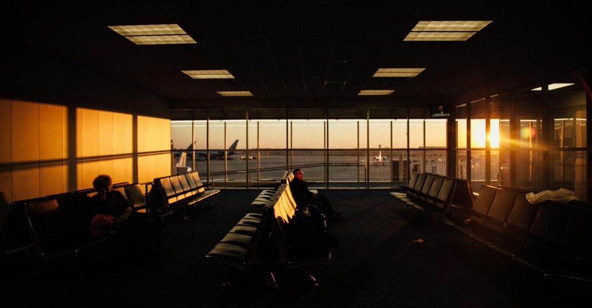 Peaceful airport waiting area with sunset silhouettes and quiet ambiance