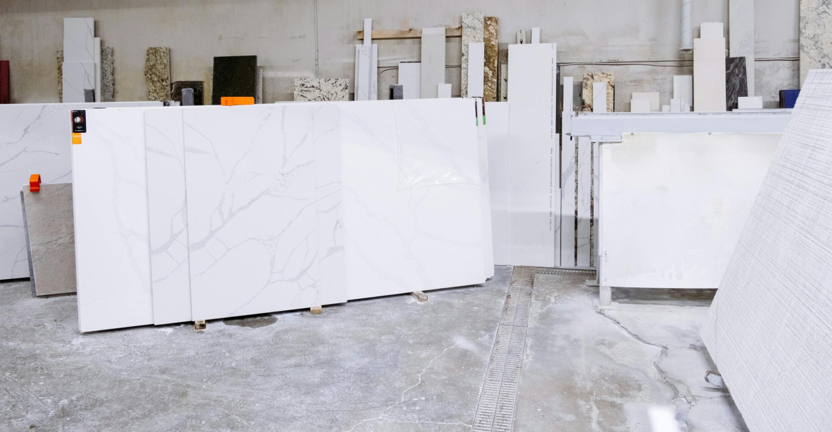 Granite and stone slabs in a manufacturing facility showing industrial processes.