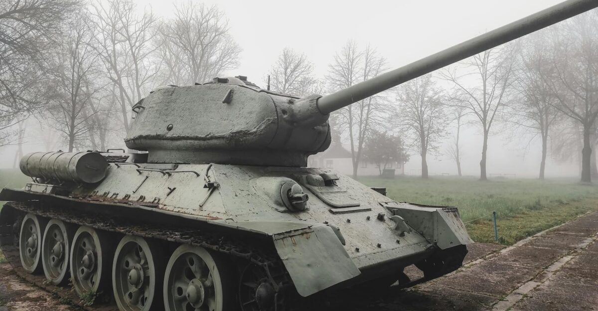 Soviet T-34 tank displayed outdoors on a foggy winter morning surrounded by trees