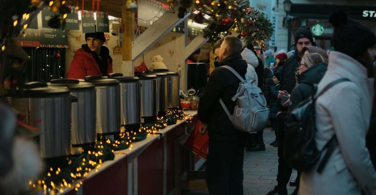 Experience the festive charm of a winter market in Bratislava with joyful crowds and cozy vendors