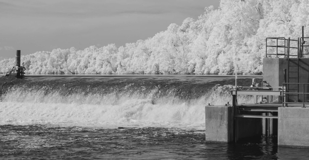 Monochrome infrared photo of a dam over a river in Columbia, South Carolina, showcasing unique infrared aesthetic.