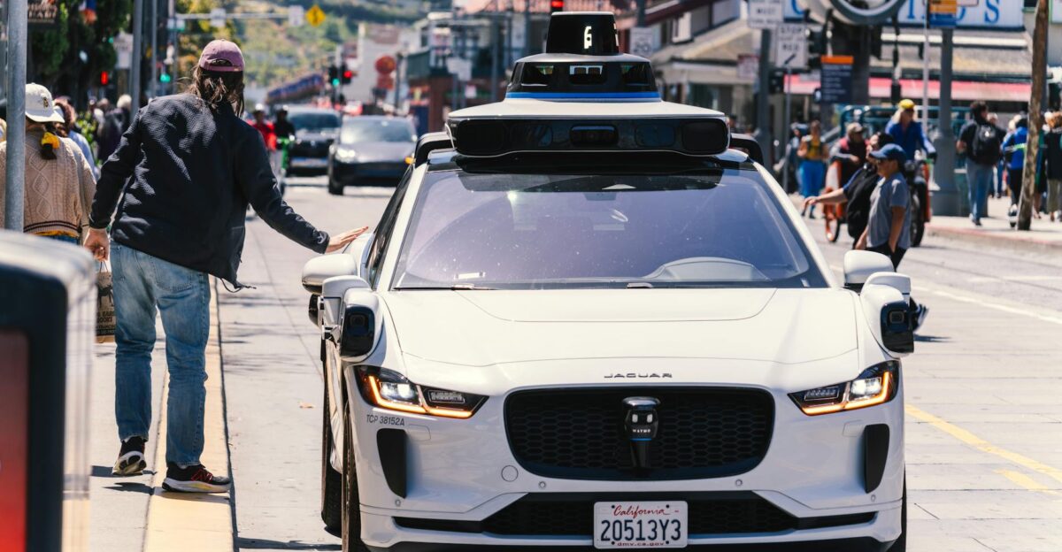 A self-driving car navigates through a bustling city street in San Francisco capturing urban mobility in action