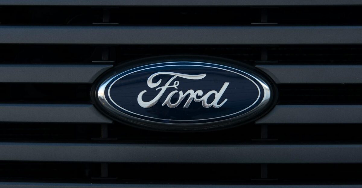 Detailed view of a Ford emblem mounted on a vehicle grille showcasing modern design