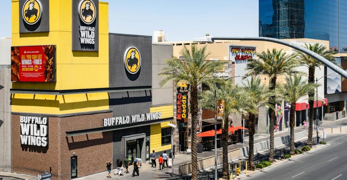 Buffalo Wild Wings located on the bustling Las Vegas Strip with palm trees and pedestrians
