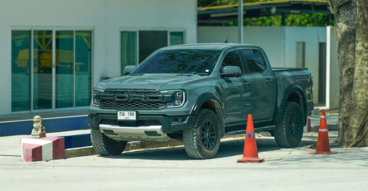 Green off-road vehicle parked outdoors in urban Phuket Thailand
