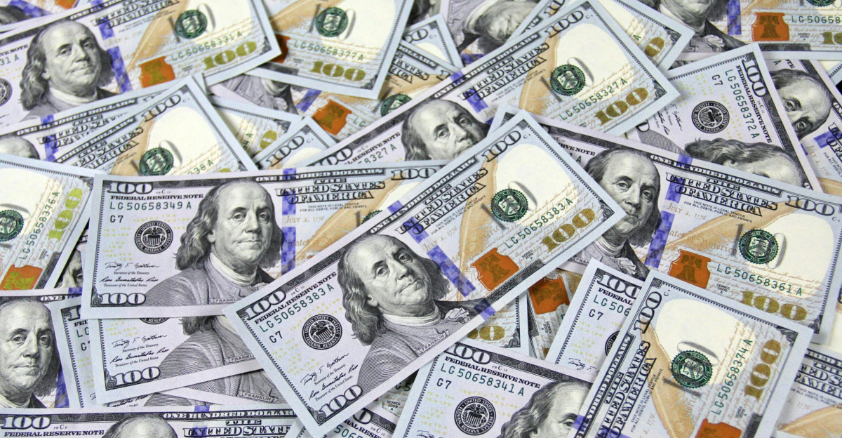 Pile of US hundred dollar bills depicting financial success and wealth.